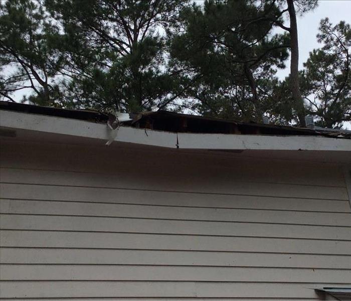broken roof edge from tree damage  storm