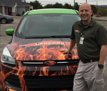 SERVPRO employee standing in front of truck