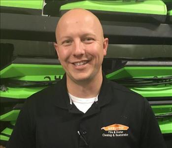 A male SERVPRO employee standing in front of equipment. 