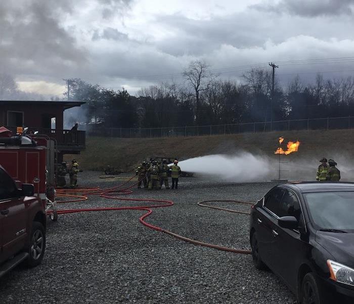 Firefighter recruits at a live burn training simulation