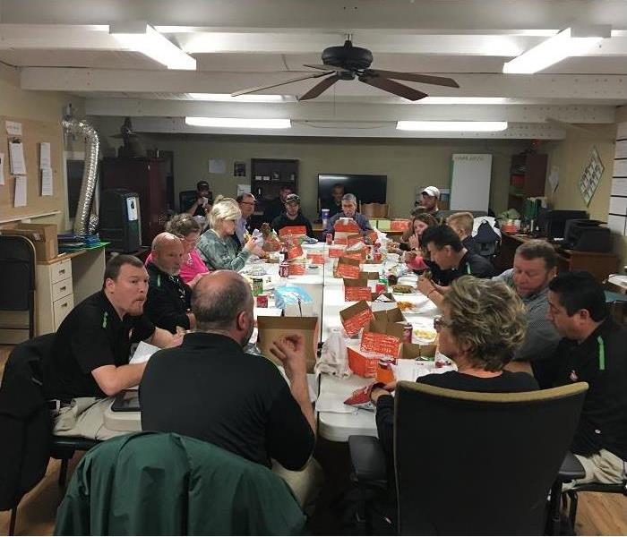 SERVPRO employees sitting around the table eating dinner
