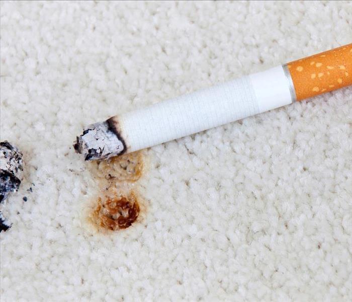 cigarette burn on white carpet